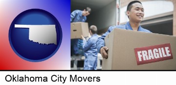 movers unloading a moving van and carrying a fragile box in Oklahoma City, OK